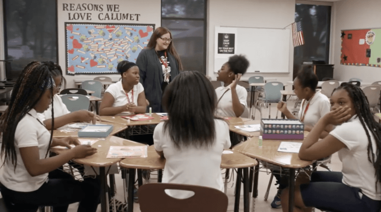 Teacher talking with a group of girls in a circle