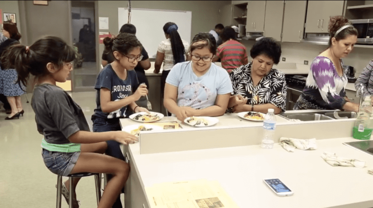 Group of students eating food in home ec class