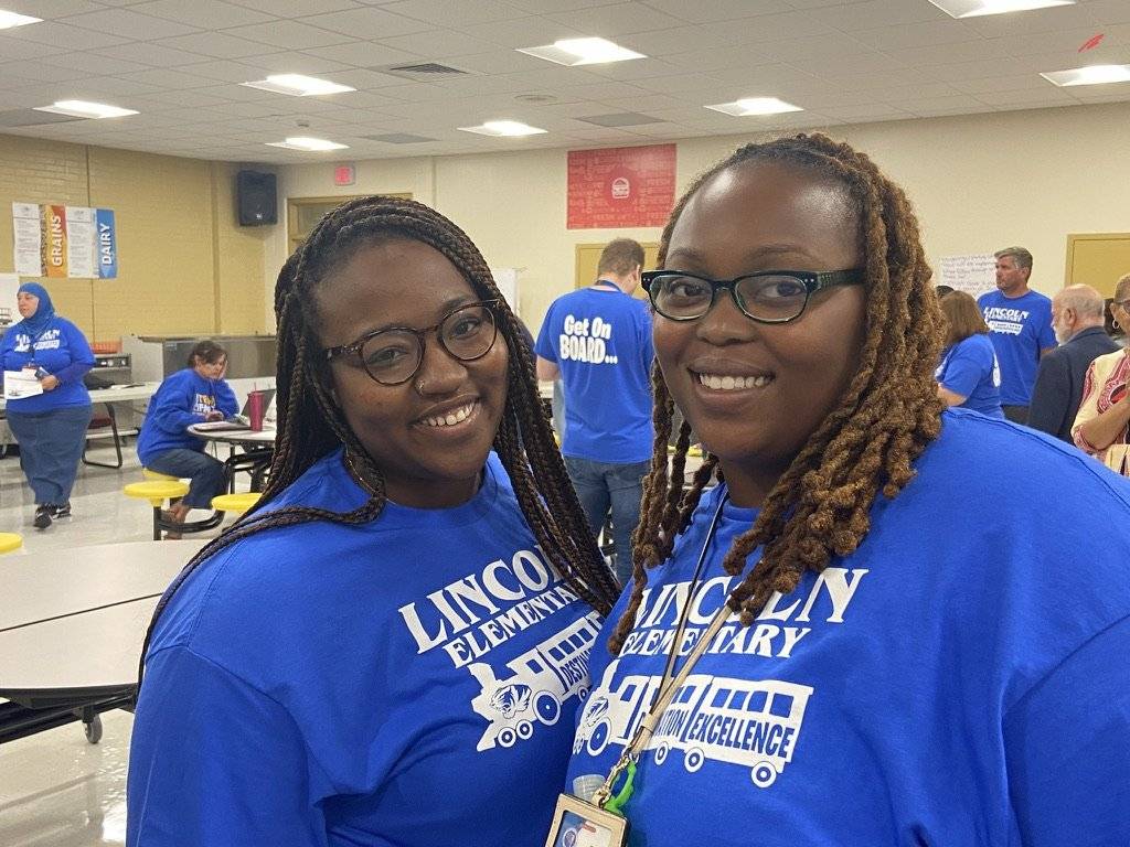Two Lincoln elementary school teachers posing together at event